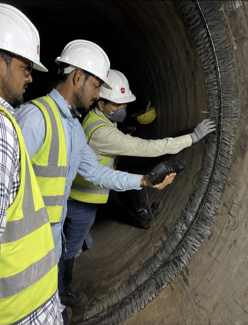NDT inspectors conducting ultrasonic testing inside a tunnel bore